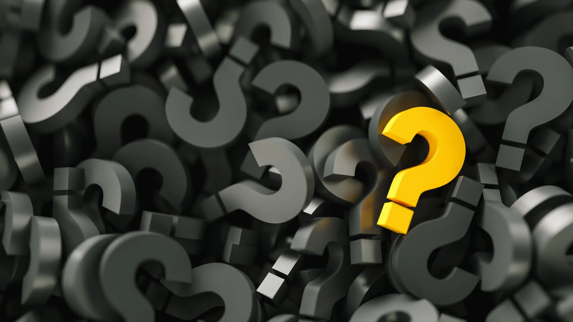 Yellow question mark in an ocean of black question marks - marketing faqs